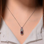 rubellite tourmaline pink sapphire and zircon ornate halo pendant necklace in rhodium over sterling silver worn around the neck