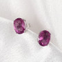 pink fluorite 8x6mm oval stud earrings in rhodium over sterling silver shown in a lifestyle photo