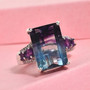 angled view of rainbow fluorite emerald cut amethyst and zircon ring in rhodium over sterling silver