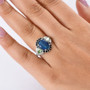 australian boulder opal triplet and multi gem halo ring in rhodium over sterling silver worn on a hand