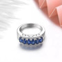 close up of oval sapphire and white zircon band ring in rhodium over sterling silver