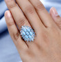 turquoise blue topaz and black spinel cluster ring in rhodium over sterling silver shown for size comparison