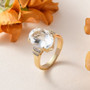 hyalite opal and diamond ring in 10k yellow gold shown in a lifestyle photo