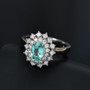 close up of paraiba tourmaline and diamond oval double halo ring in platinum emphasizing clarity and symmetry of stones