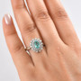 paraiba tourmaline and diamond oval double halo ring in 950 platinum shown for size comparison