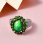 ammolite chrome diopside and zircon halo triple shank ring in rhodium over sterling silver shown in a lifestyle photo