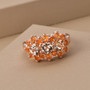 close up of imperial topaz and fire opal cluster ring in 18k rose gold over sterling silver