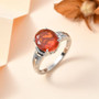 mexican fire opal and diamond platinum ring displayed on neutral background showing vivid orange brilliance