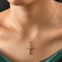 spun gold 10k yellow gold cross pendant necklace worn on model showing scale and neckline placement