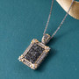indian alexandrite and white zircon fleur-de-lis cluster pendant necklace in 18k yellow gold and rhodium over sterling silver shown in a lifestyle photo