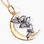 angled view of bat and crescent moon pendant necklace in 18k yellow gold and black rhodium over sterling silver
