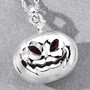pumpkin pendant with garnet eyes on gray background polished rhodium over sterling silver