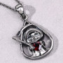 gothic reaper pendant with red garnet heart on gray background crafted in black rhodium over sterling silver