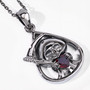 angled view of grim reaper faceted garnet heart pendant necklace in black rhodium over sterling silver