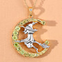 close up of flying witch and crescent moon two-tone pendant necklace with peridot and white topaz in 18k yellow gold and rhodium over sterling silver