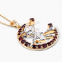 side view of flying witch and crescent moon two-tone pendant necklace with garnet and white topaz in 18k yellow gold and rhodium over sterling silver