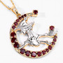 angled view of flying witch and crescent moon two-tone pendant necklace with garnet and white topaz in 18k yellow gold and rhodium over sterling silver