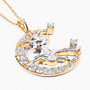 angled view of flying witch and crescent moon two-tone pendant necklace with sky blue topaz and white topaz in 18k yellow gold and rhodium over sterling silver