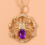 close up of spider web pendant necklace with amethyst and white topaz in 18k yellow gold over sterling silver
