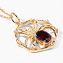 angled view of spider web oval pendant necklace with garnet and white topaz in 18k yellow gold over sterling silver