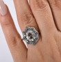 color change garnet and white zircon deco inspired halo ring in rhodium over sterling silver shown for size comparison