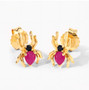 angled view of spider stud earrings with ruby and black spinel in 18k yellow gold over sterling silver