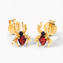 angled view of spider stud earrings with garnet and black spinel in 18k yellow gold over sterling silver