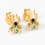 close up of gold spider stud earrings featuring green peridot and black spinel gemstones in sterling silver