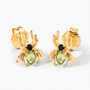 angled view of spider stud earrings with peridot and black spinel in 18k yellow gold over sterling silver