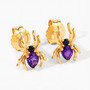 close up of spider stud earrings with amethyst and black spinel in 18k yellow gold over sterling silver