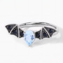 front view of bat wing ring with sky blue topaz and black spinel in black and white rhodium over sterling silver