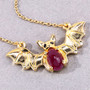 close up of bat necklace with ruby and black spinel in 18k yellow gold over sterling silver