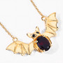 angled view of bat necklace oval with garnet and black spinel in 18k yellow gold over sterling silver