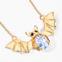 angled view of bat necklace oval with sky blue topaz and black spinel in 18k yellow gold over sterling silver