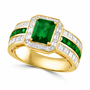 angled front view of emerald cut emerald ring with diamond halo and channel set diamonds in 14k yellow gold