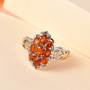 angled studio image of orange kyanite cluster ring showing ornate two-tone detailing