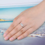 aquamarine white zircon and emerald cut solitaire ring in rhodium over sterling silver