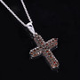 angled view of red diamond cluster cross in black and white rhodium over sterling silver