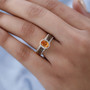 spessartine garnet and zircon ring in yellow gold plated sterling silver worn on hand showing vivid orange gemstone and contrast