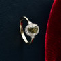 demantoid garnet and diamond oval halo ring in 10k yellow gold