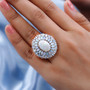 australian white opal and moissanite halo ring in rhodium over solid 925 sterling silver worn on a hand