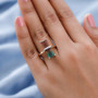 watermelon tourmaline and diamond ring in 10k yellow gold shown on hand emphasizing the bold elongated gemstone and artistic color transition from pink to green