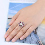 opal and rhodolite garnet flower ring in rhodium over sterling silver worn on a hand