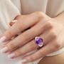 amethyst trilogy ring in 18k yellow gold and rhodium over 925 sterling silver worn on a hand