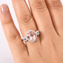 morganite paraiba oval tourmaline and diamond halo ring in 10k rose gold worn on a hand