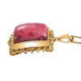 side view of thulite and cabochon chrome diopside pendant necklace in 18k yellow gold over sterling silver