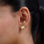 pumpkin stud earrings with white zircon in 18k yellow gold over 925 silver worn on the ear