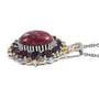 side view of thulite and rhodolite halo pendant necklace in two-tone 18k yellow gold and rhodium over sterling silver