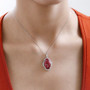 thulite and white zircon oval halo pendant necklace in rhodium over sterling silver worn around the neck