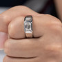 men’s emerald-cut moissanite ring worn on hand, showcasing modern minimalist design in rhodium over sterling silver
